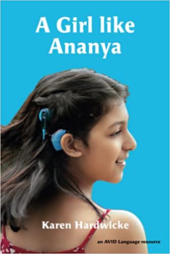 The cover of the book “A Girl Like Ananya” features a bright blue background with the title and author’s name, Karen Hardwick, at the top. In the middle, a smiling teenage girl wearing a spaghetti strap tank top and a blue cochlear implant processor looks over her right shoulder.