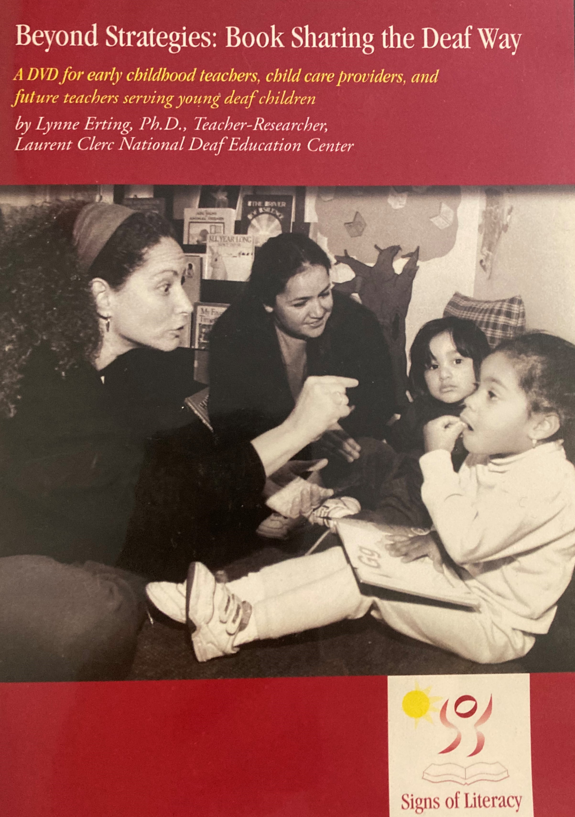 A DVD case with a red background and the title "Beyond Stargies: Book Sharing the Deaf Way" at the top. Below a text in yellos describes "A DVD for early childhood teachers, child care providers, and future reachers erving young deaf children." Two adult females look at two young girls. One girl has an alphabet book open on her lap to the letter G and one adult is showing the girl the sign for g with her right hand.