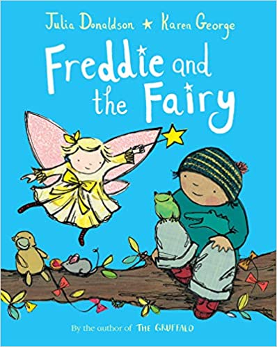The cover of the book "Freddie and the Fairy" features an illustrated bright blue background with the title across the top and a tree branch at the bottom. A smiling boy on the right, wearing a green stocking cap, sits on the branch looking at a fairy wearing a yellow dress with pink wings and holds a yellow star wand flying above the branch.