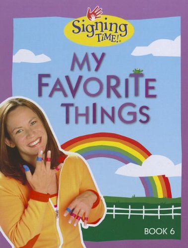 The cover of the book "My Favorite Things" has the title at the top in purple along with the Signing Time logo and a purple outside border. A smiling woman is at the bottom left wearing a yellow shirt using American Sign Language. In the background, an illustrated outdoor screen with a rainbow and a white fence.