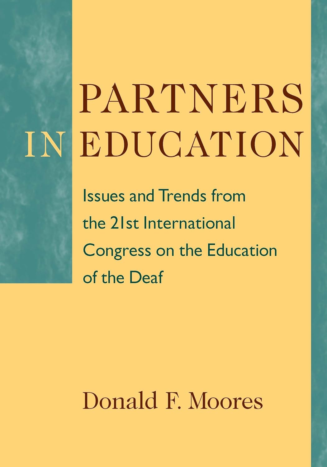 The cover of the book "Partners in Education: Issues and Trends from the 21st International Congress on the Education of the Deaf" features a yellow and green back with the title at the top. The author's name, Donald F. Moores, apears at the bottom.