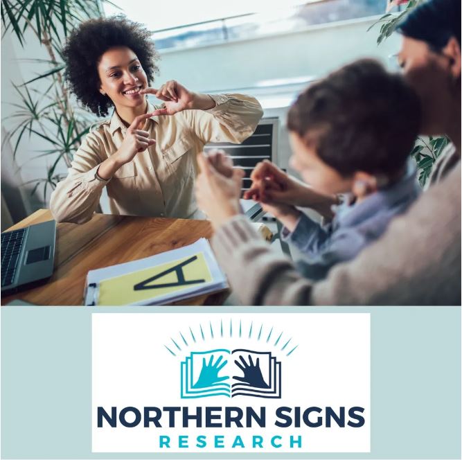A smiling woman on the left is signing to a child sitting on a second woman's lap. The woman's hands are on top of the child's hands supporting the child to creat the sign with his hands. The Nothern Signs Research