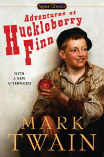 A boy wearing a hat and holding a red apple