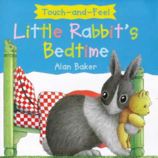 A rabbit next to a bed holding a teddy bear.