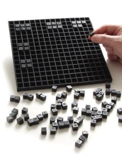 Picture of cube slate with small black cubes. 