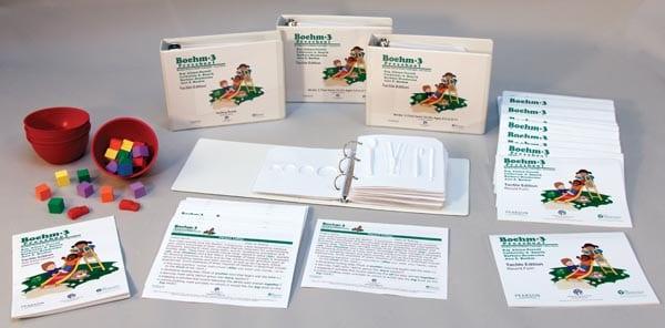Picture of Boehm kit contents with binders, booklets and red bowls with manipulatives.