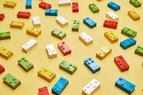 Lego braille bricks in various colors. 