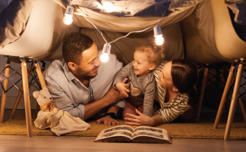 family with small child reading together